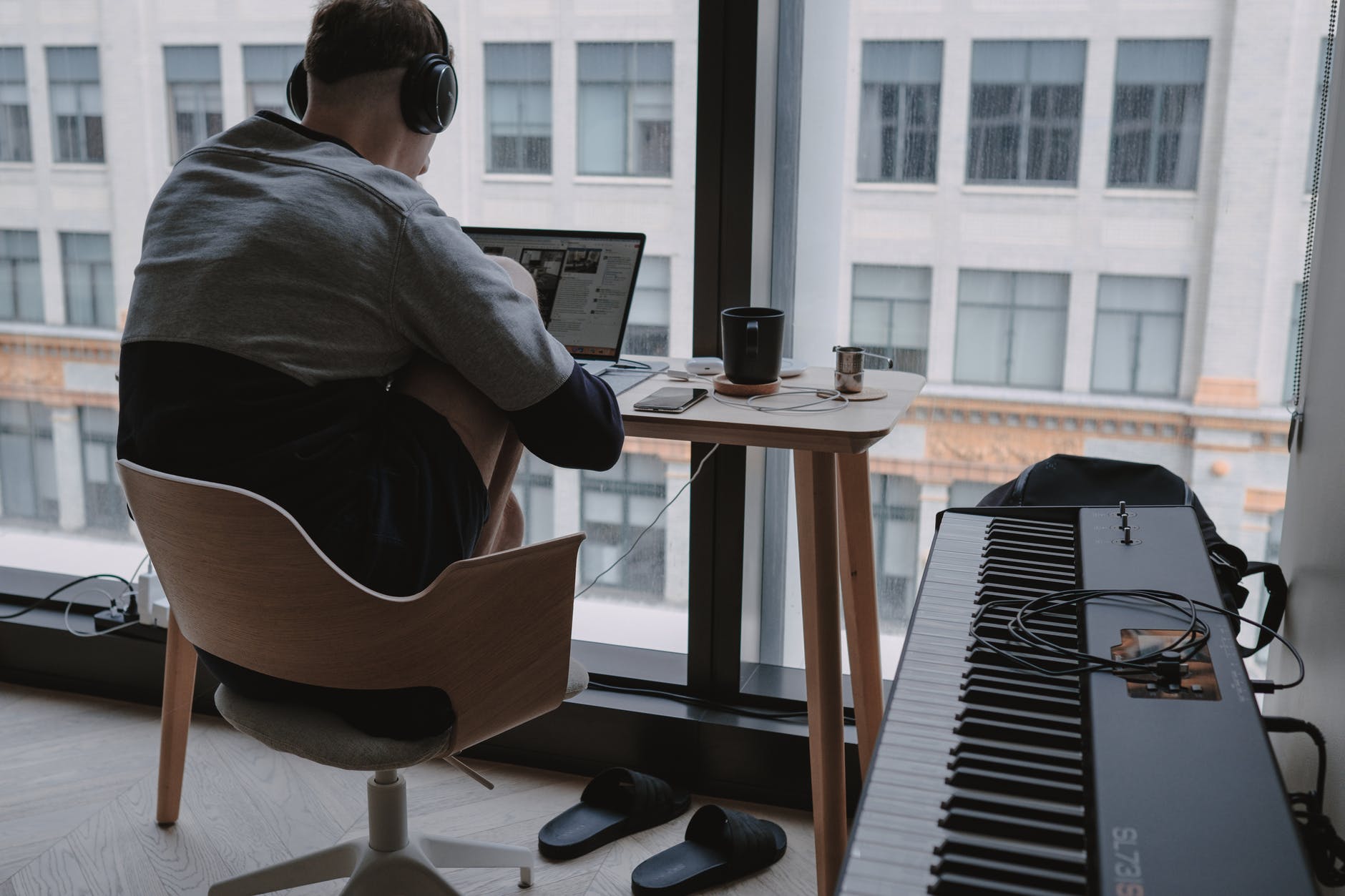 2021: man in gray shirt sitting on chair in front of computer