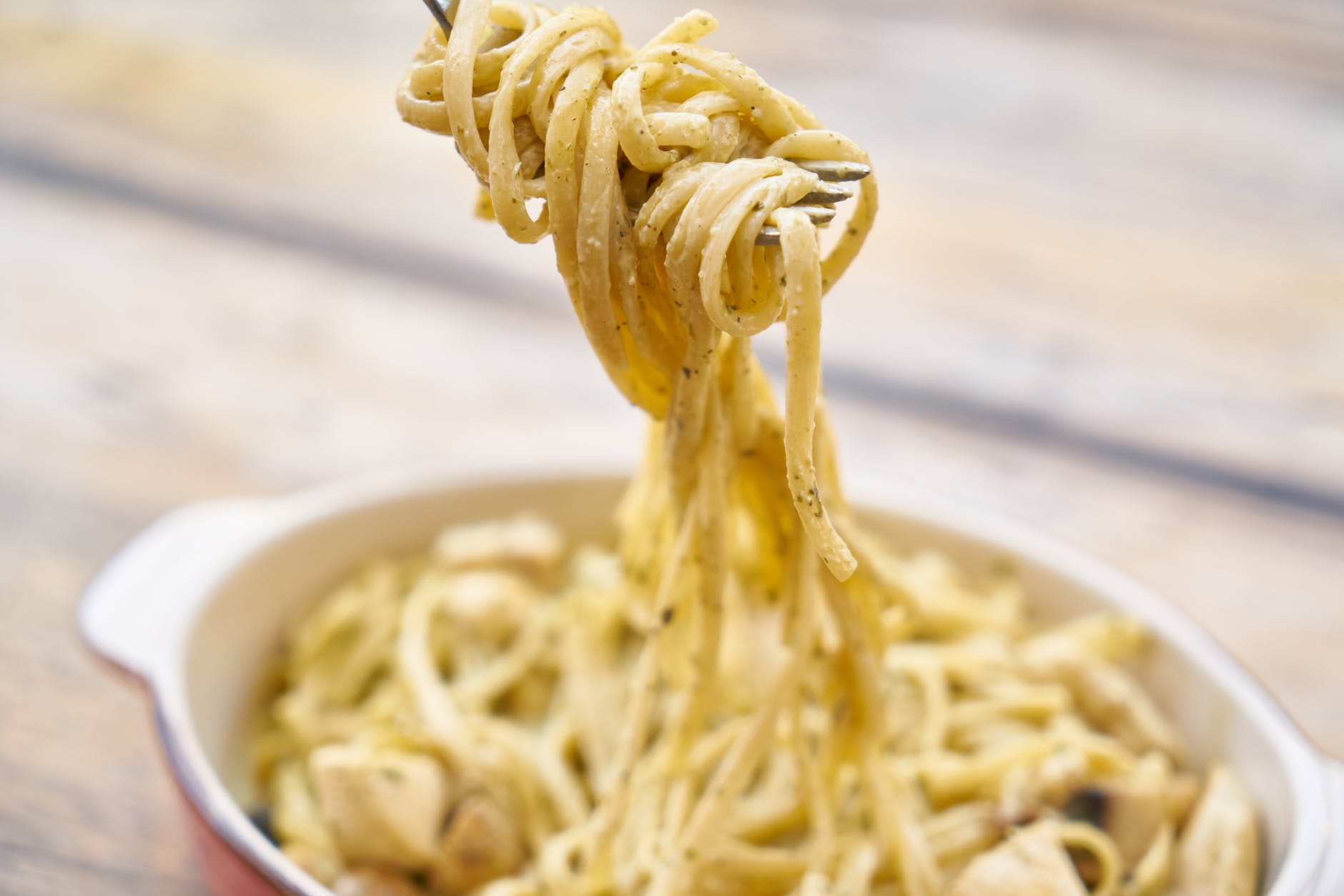 A steaming plate of creamy cacio e pepe pasta on a rustic wooden table, symbolising comfort, mindfulness and the simple joys of Italian life.