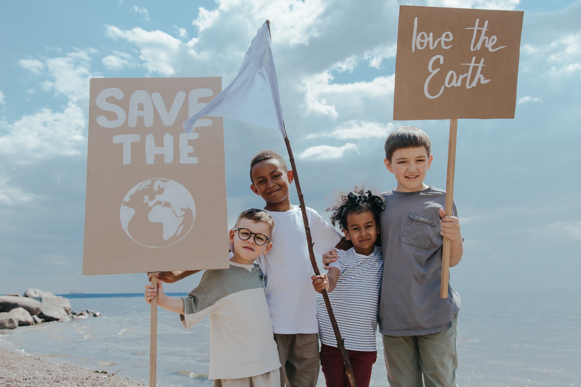 children standing together while holding signages
