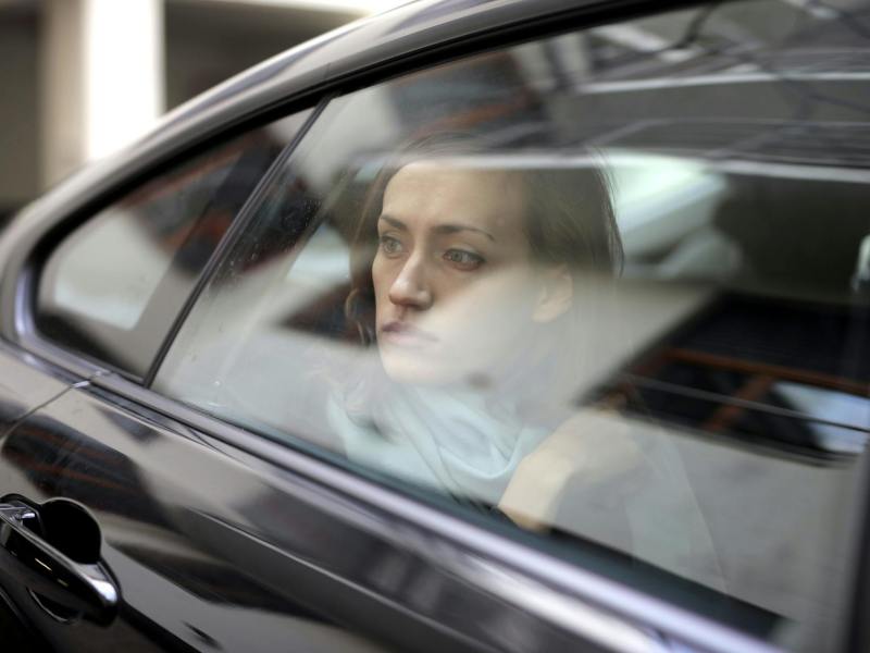 woman looking out while sitting inside the car