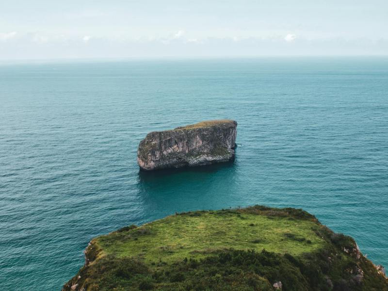 lone rock out in sea next to Asturias