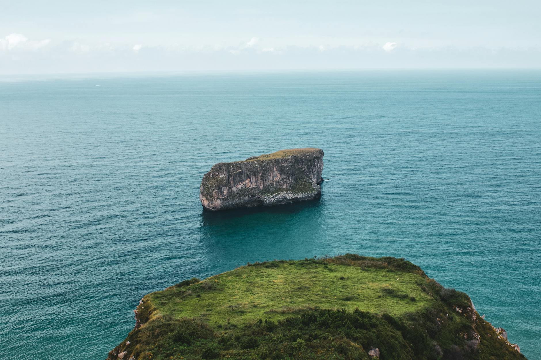 lone rock out in sea next to Asturias