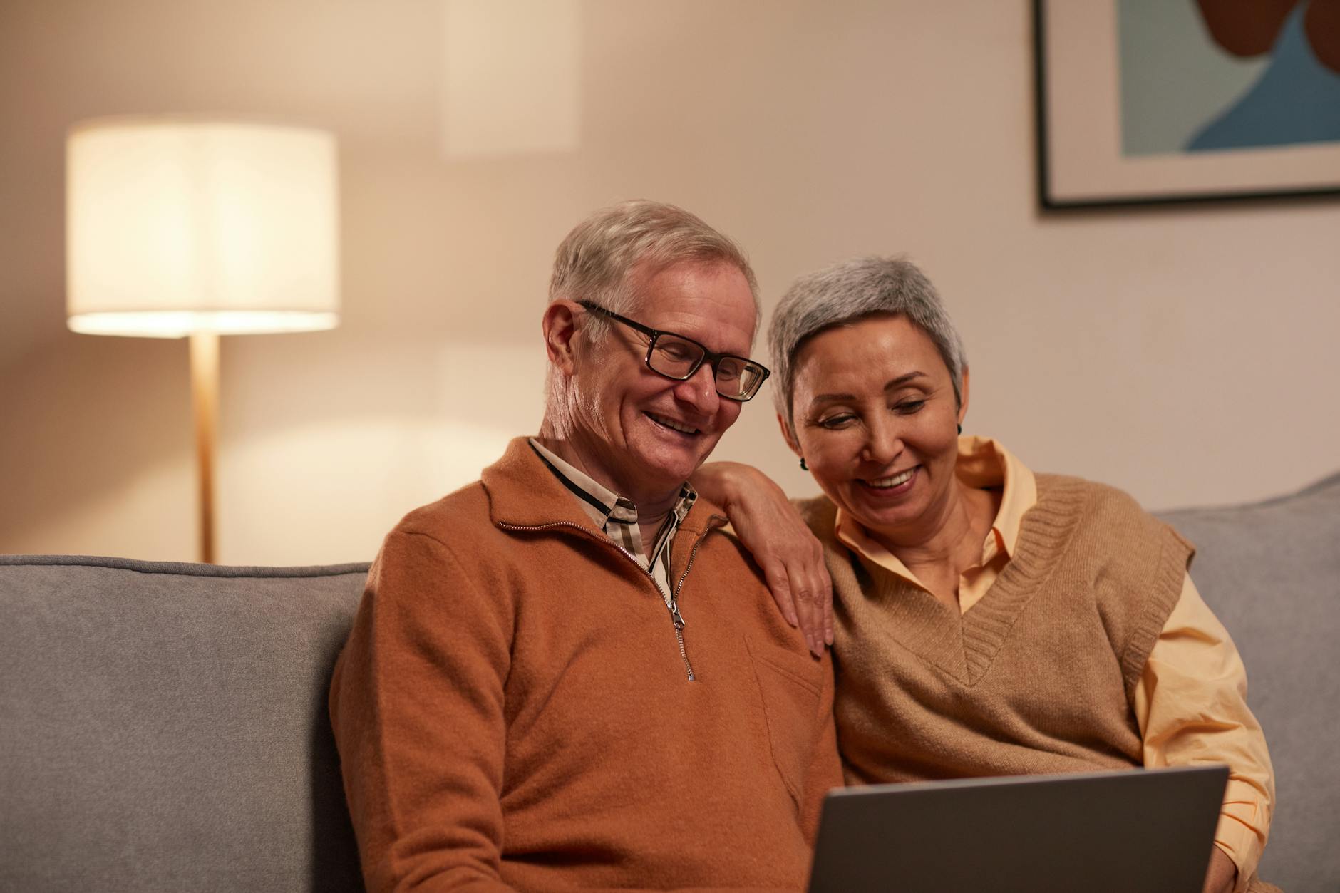 Longevita' in Sardegna man and woman sitting on sofa while looking at a laptop