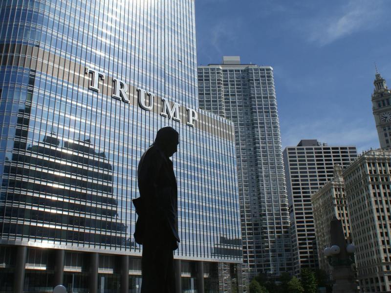 silhouette of statue near trump building at daytime