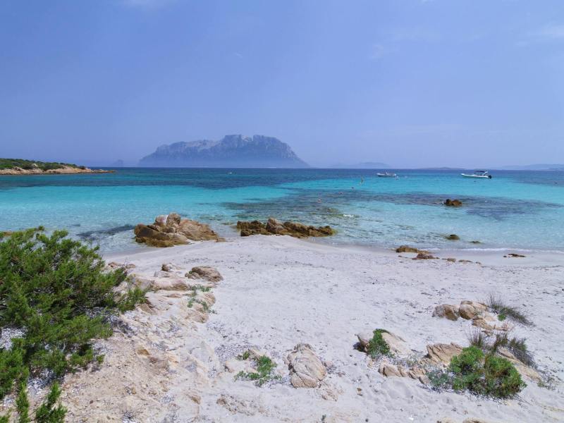 idyllic beach view with turquoise waters and rocky shoreline