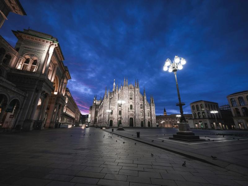 classic buildings on square at night in Milano