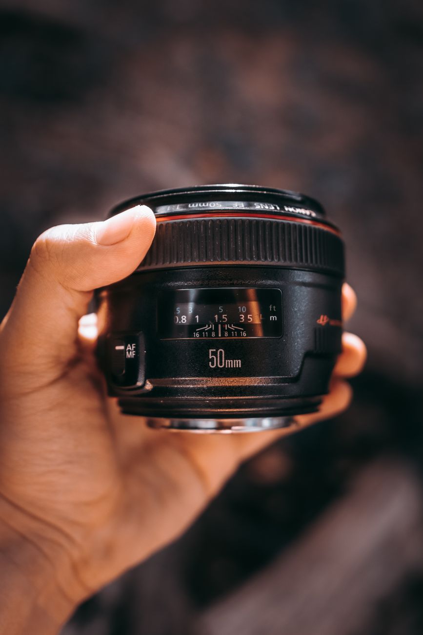 person holding black camera lens